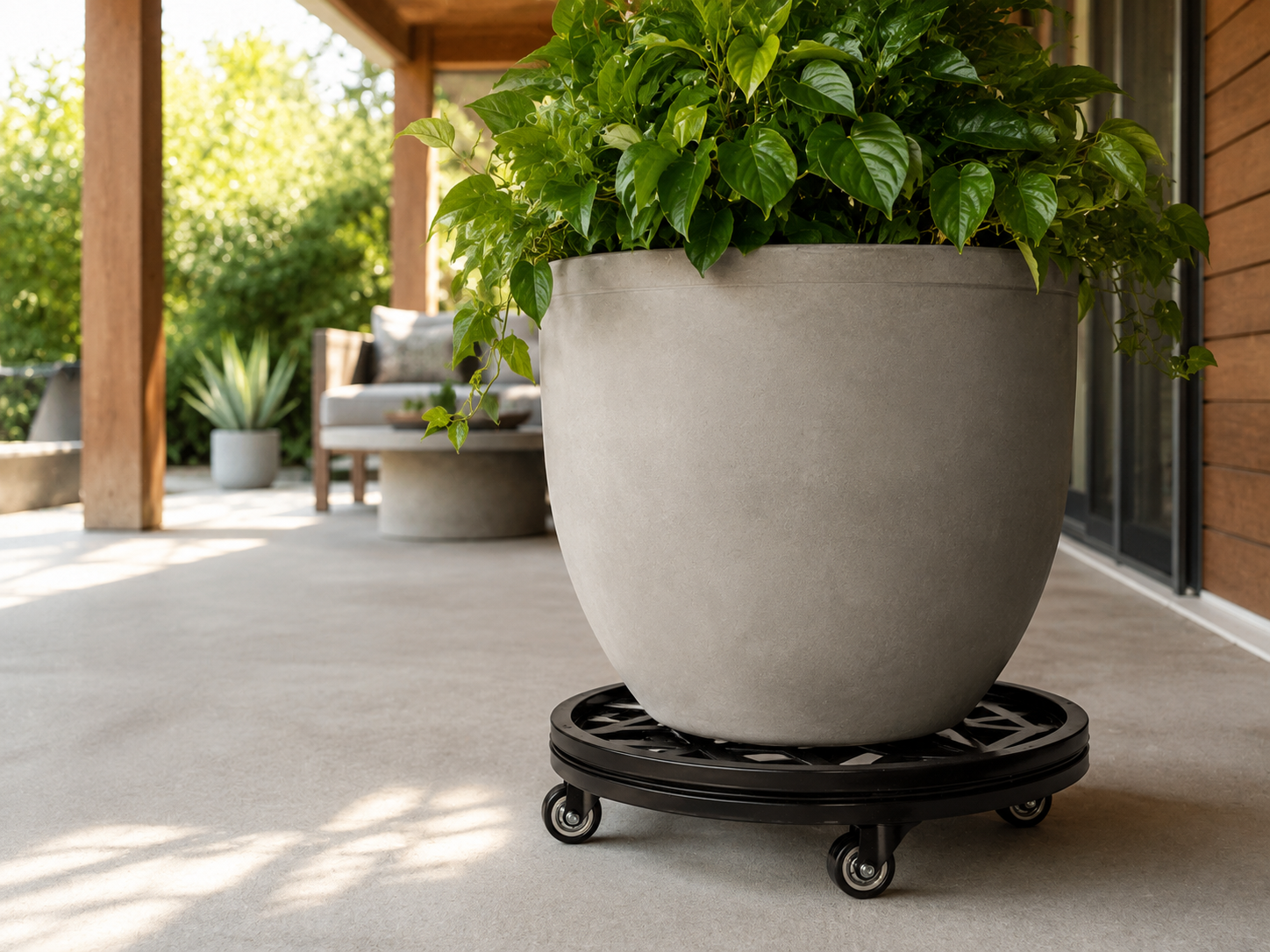 Stylecraft black steel plant caddy supporting a large planter on a patio