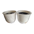 Front view of the actual Trendspot Theo 18-inch white resin planter two-pack on studio white
