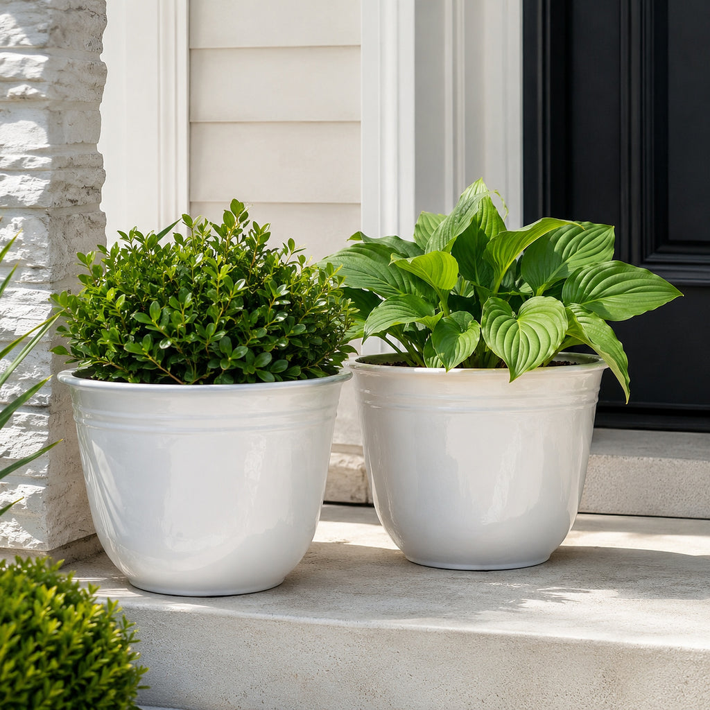 Illustrative lifestyle scene showing two white 18-inch planters in use on a front porch