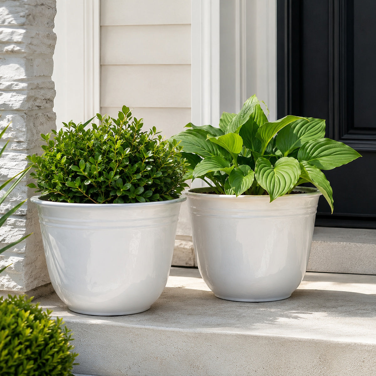 Illustrative lifestyle scene showing two white 18-inch planters in use on a front porch