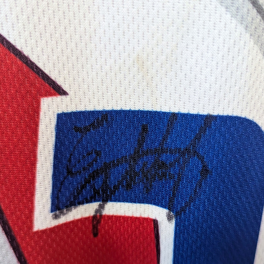 Close-up of Emilker Guzman's autograph on the blue number 2 of the game-worn jersey